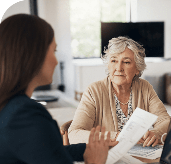 Older woman discussing documents with younger woman.