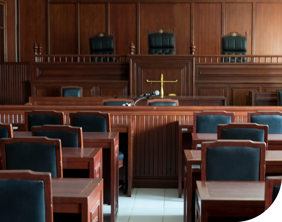 Empty courtroom with wooden furniture and chairs.
